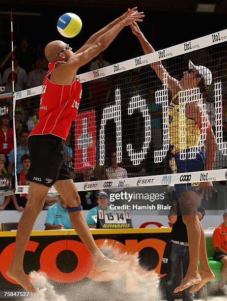 Phil Dalhausser of USA attempts to block a shot from Emanuel Rego of Brazil during the semi final between Todd Rogers and Phil Dalhausser of USA and...