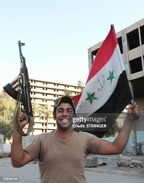 An Iraqi soldier celebrates the victory of his country's football team against Saudi Arabia for the final of the Asian Football Cup 2007, 29 July...