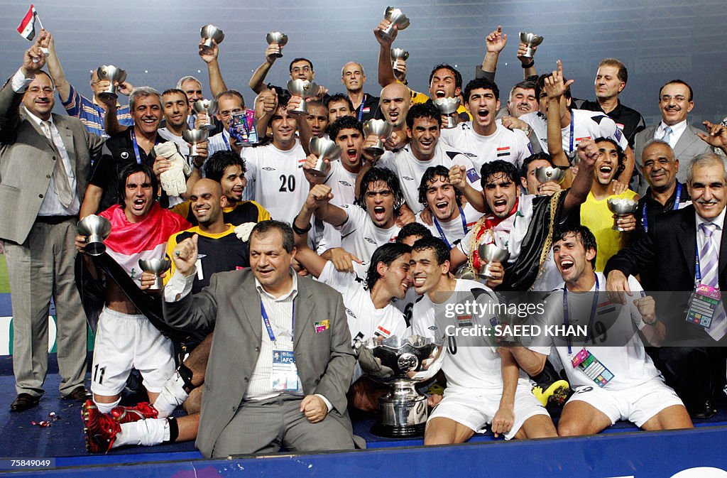 Jubilant Iraq's national football team members pose with their winning trophy during the presentation at the end of the final match of the Asian Football Cup 2007 at the Bung Karno stadium in Jakarta, 29 July 2007. Skipper Younis Mahmoud's thumping headed goal crowned Iraq as the Asian Cup champions for the first time with a stirring 1-0 win over Saudi Arabia in the final. AFP PHOTO/Saeed KHAN (Photo credit should read SAEED KHAN/AFP via Getty Images)