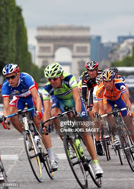 France's Christophe Moreau rides with The Netherlands' Michael Boogerd ride down the Champs Elysees during the 146 km twentieth and last stage of the...