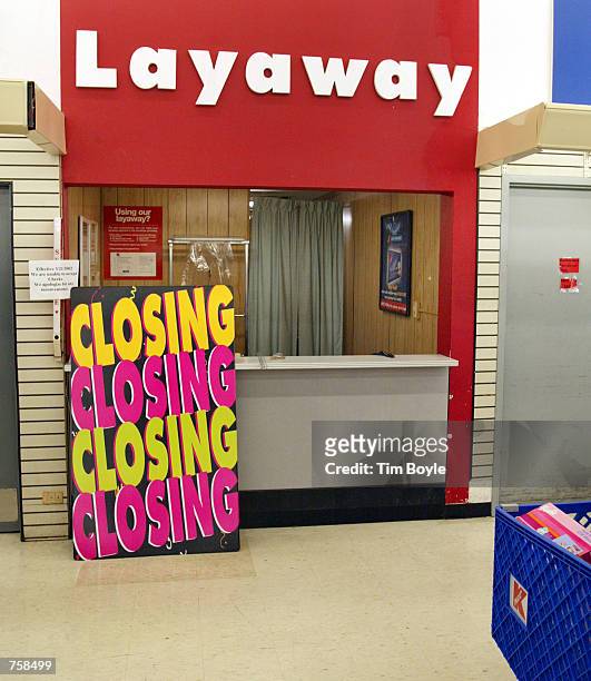 Large sign that reads "Closing Closing Closing Closing" sits at the Layaway department in a Kmart store March 25, 2002 that is scheduled for closing...