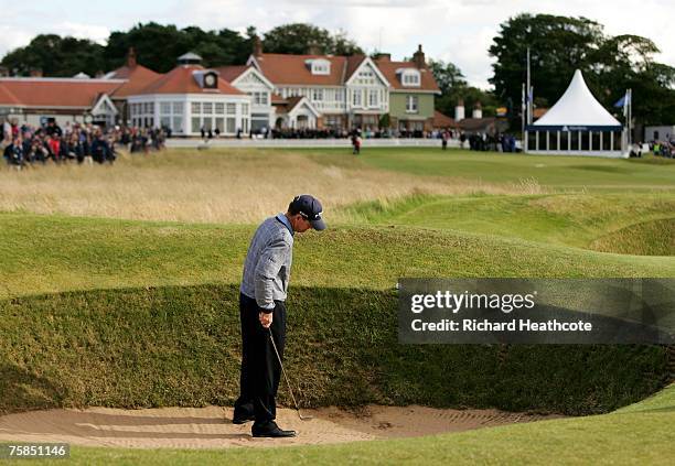 Tom Watson of the USA hits his second shot from the bunker on the 18th and watches it roll back into the bunker during the final round of The Senior...