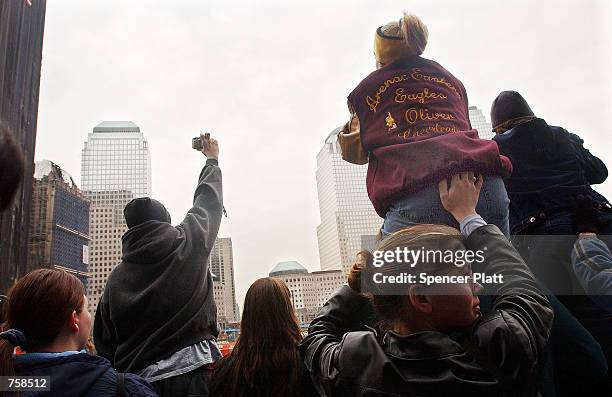 Tourists try to get a view of the site of ground zero at the World Trade Center March 25, 2002 in New York City. Six months after the September 11...