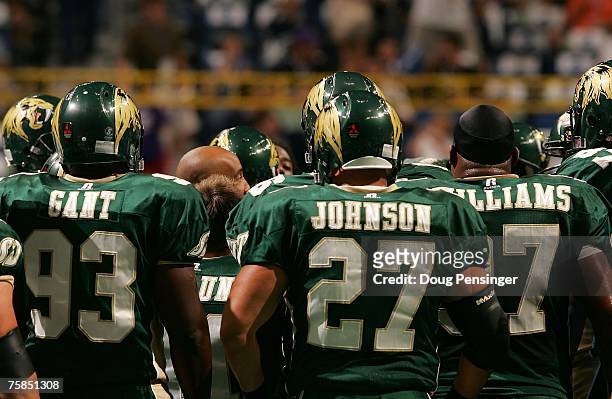 Members of the San Jose SaberCats huddle up around head coach Darren Arbet during warm-ups prior to ArenaBowl XXI against the Columbus Destroyers at...
