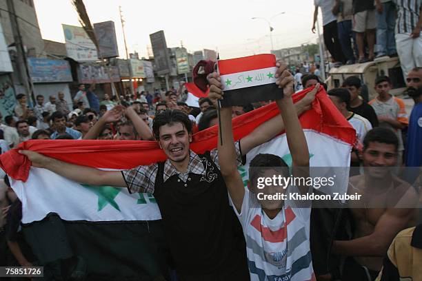 Iraqis celebrate after the Iraqi team won the final game of the 2007 AFC Asian Cup soccer tournament against Saudi Arabia, July 29, 2007 in Basra,...