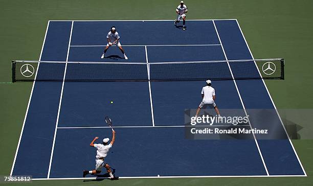 Juan Martin Del Potro of Argentina and Travis Parrott play a point with Teimuraz Gabashvili of Russia and Ivo Karlovic during the doubles final of...