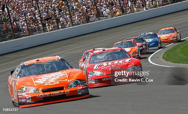 Tony Stewart, driver of the Home Depot Chevrolet, races Dale Earnhardt Jr., driver of the Budweiser Chevrolet, during the NASCAR Nextel Cup Series...