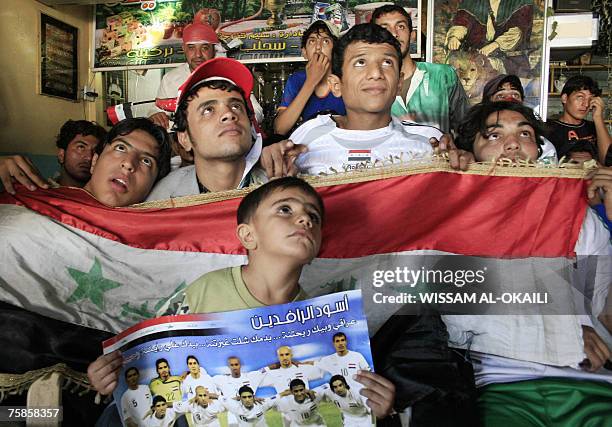 Iraqi supporters watch the final match of the Asian Football Cup 2007 between Iraq and Saudi Arabia , 29 July 2007 at a cafe in Baghdad. Iraq erupted...