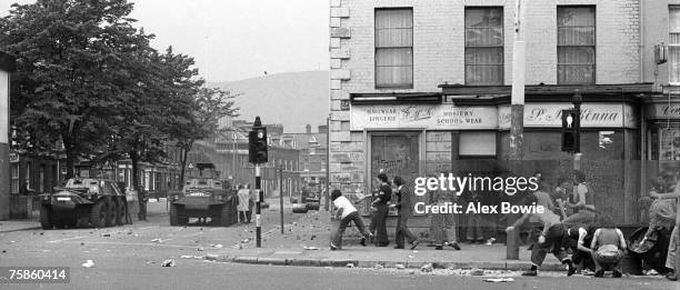 Teenagers throw stones at the British Army during rioting on the republican Falls Road in Belfast, 17th September 1976. The heavily fortified...