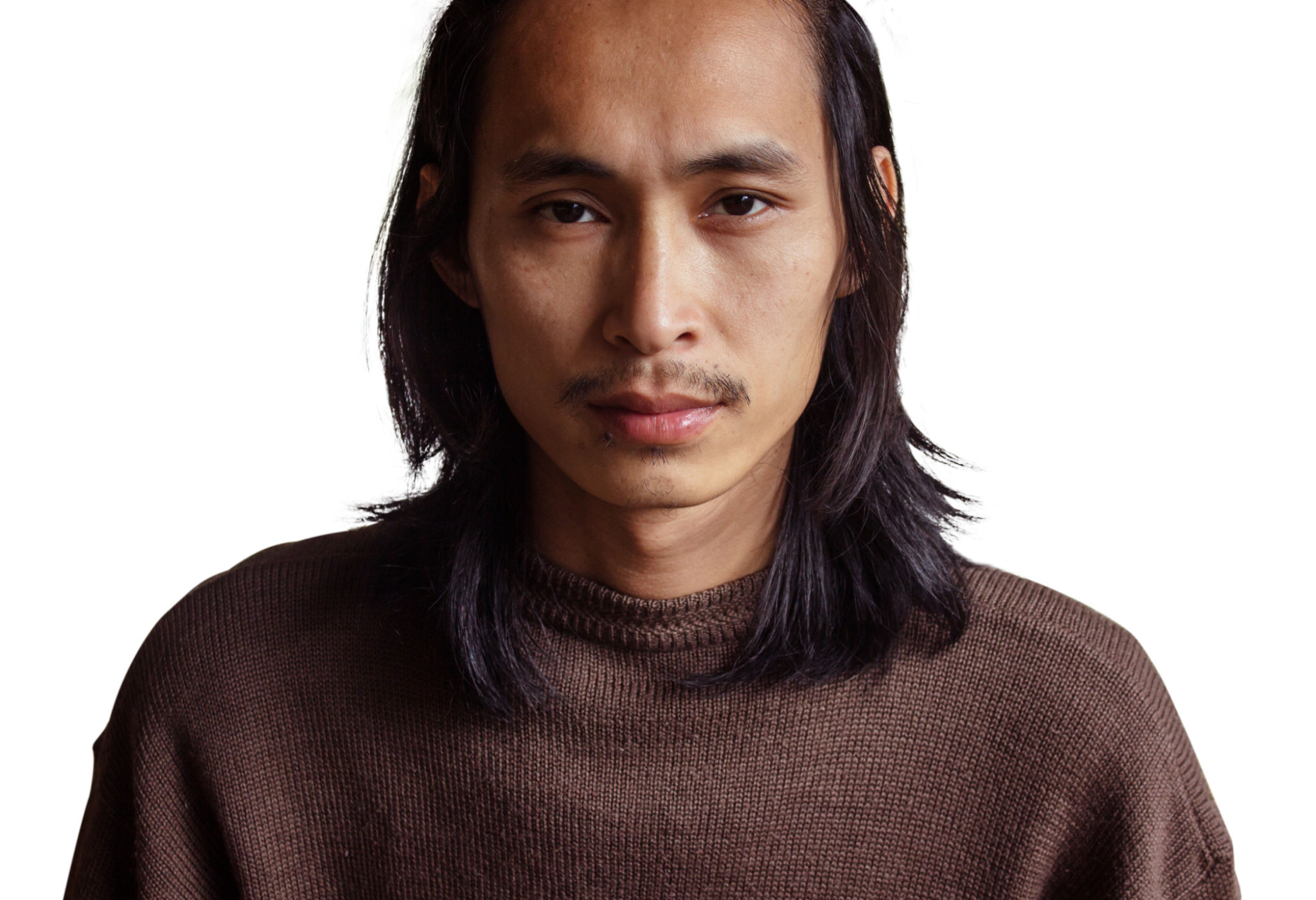 Close-Up Portrait Of Man With Long Hair Against White Background Close-Up Portrait Of Man With Long Hair Against White Background