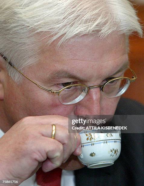 German Foreign Minister Frank-Walter Steinmeier drinks coffee in the Andrassy Hall of the foreign affairs ministry building of Budapest 30 July 2007...