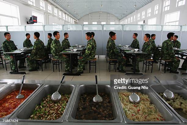 Chinese soldiers from the People's Liberation Army 196th Infantry Brigade take lunch after performing military drill, artillery and hand-to-hand...