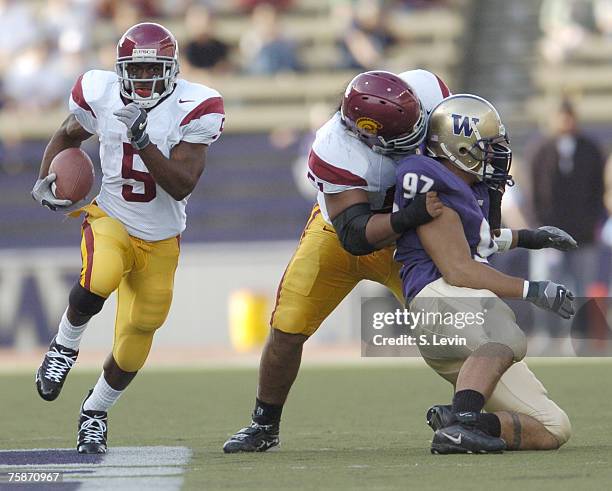 Trojans Reggie Bush finds a hole during the game between the USC Trojans and the University of Washington Huskies at Husky Stadium in Seattle, WA on...