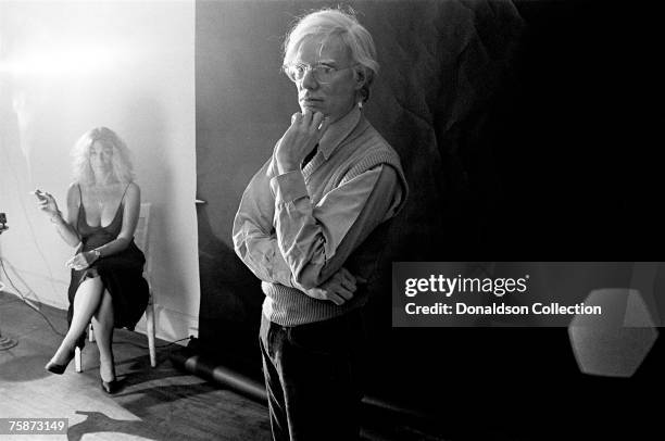 Artist Andy Warhol with Sylvia Miles pose for a photo shoot at the Factory in New York.