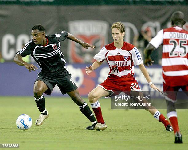 Luciano Emilio pushes the ball forward away from Clarence Goodson during a game between SC Dallas and DC United at RFK Stadium July 14, 2007 in...