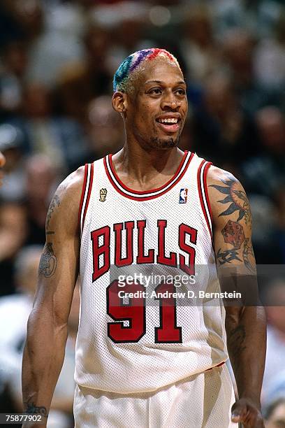 Dennis Rodman of the Chicago Bulls catches his breath during a 1996 NBA game at the United Center in Chicago, Illinois. NOTE TO USER: User expressly...