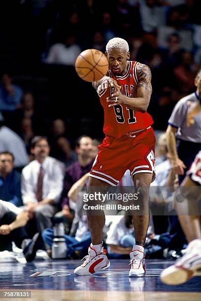 Dennis Rodman of the Chicago Bulls throws a pass during a 1996 NBA game. NOTE TO USER: User expressly acknowledges that, by downloading and or using...