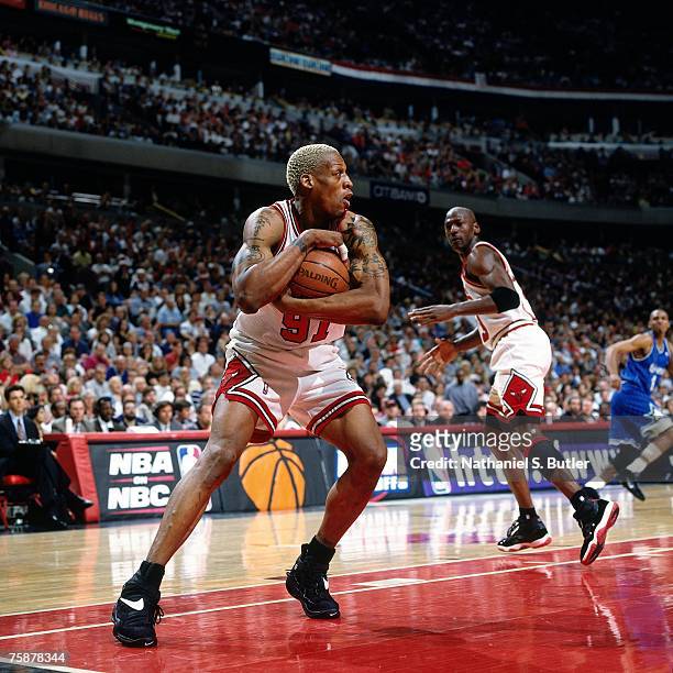 Dennis Rodman of the Chicago Bulls grabs a rebound against the Orlando Magic during a 1996 NBA game at the United Center in Chicago, Illinois. NOTE...