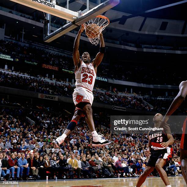 Michael Jordan of the Chicago Bulls dunks against the Portland Trail Blazers during a 1996 NBA game at the United Center in Chicago, Illinois. NOTE...