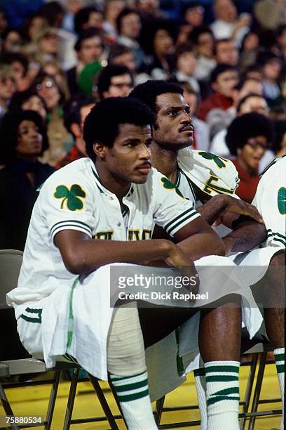 Sidney Wicks and Curtis Rowe of the Boston Celtics look on from the bench against the Houston Rockets during an NBA game circa 1976-1978 at the...