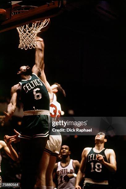 Bill Russell of the Boston Celtics attempts a dunk against the Philadelphia 76ers during an NBA game circa 1956-1969 at the Spectrum Arena in...