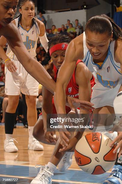 Armintie Price of the Chicago Sky battles with Crystal Smith and Tina Thompson of the Houston Comets for the loose ball at the UIC Pavilion July 29,...