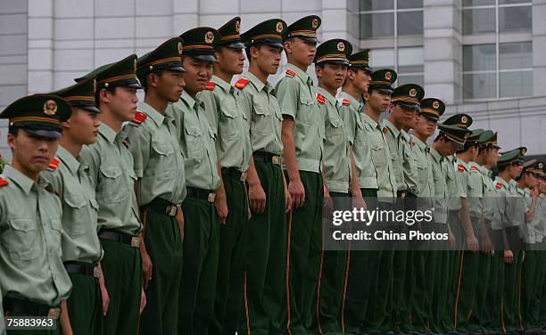 Armed policemen stand at attention during a ceremony held to celebrate the 80th anniversary of the founding of the People's Liberation Army , at the...