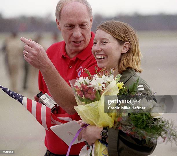 Carrine Palm, the only female pilot flying with the "Diamondbacks" of VF-102, talks with her father Dick March 26, 2002 after returning home to Naval...