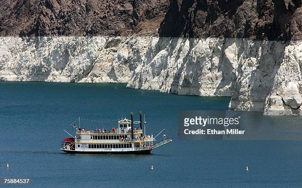 Tourists ride a paddleboat on Lake Mead on the upstream side of the Hoover Dam July 30, 2007 in the Lake Mead National Recreation Area, Nevada. The...