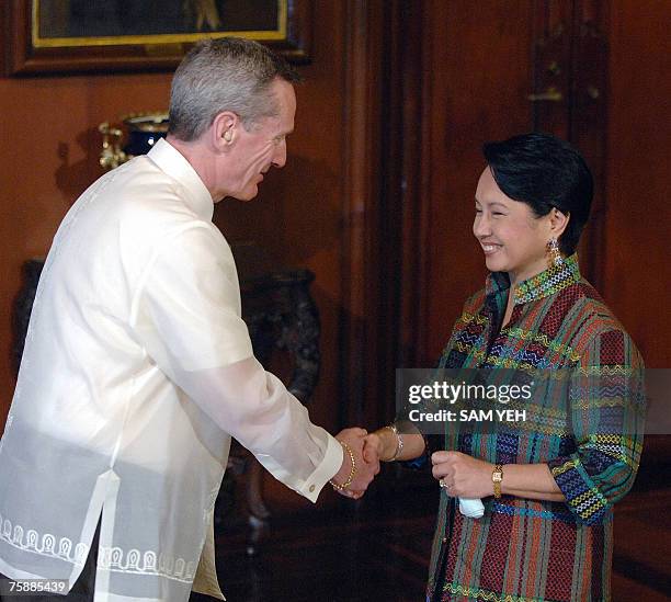 Visiting Canadian Deputy Foreign Minister Leonard Edwards is greeted by Philippines President Gloria Arroyo before dinner at Malacanang Presidential...