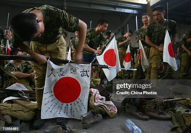 Extras dressed as Japanese soldiers, arrange properties before to shoot director Simon West's movie "Purple Mountain" July 31, 2007 in Nanjing of...