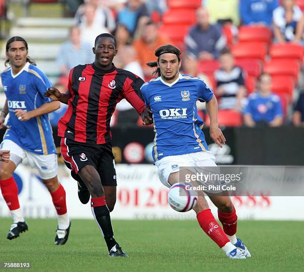 Niko Kranjcar of Portsmouth gets tackled by Marvyn Bartley of Bournmouth during the pre-season friendly match between AFC Bournemouth and Portsmouth...