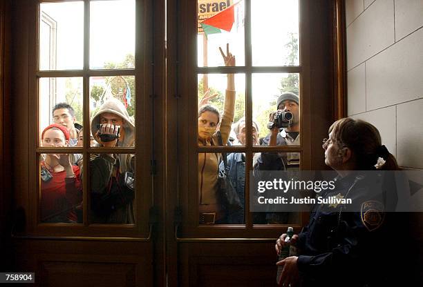 University of California at Berkeley police officer Debra Schnek guards a door to a building where dozens of pro-Palestinian demonstrators held a...