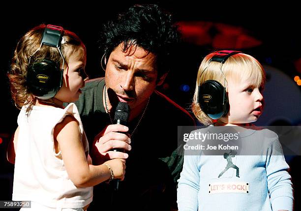 Musician Chris Cornell and his children Toni and Christopher on stage during a concert at the Beacon Theatre July 31, 2007 in New York City.