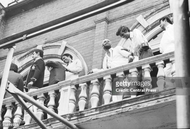 Indian players celebrate on a balcony at the Oval, London, 25th August 1971, after India won the Third Test against England by four wickets to win...