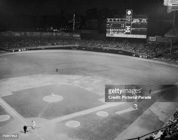 Floodlit baseball match in progress between the Boston Red Sox and home team the New York Yankees at Yankee Stadium in the Bronx, New York City, July...