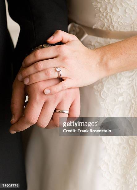 bride and groom with wedding rings, holding hands, mid section - married stock pictures, royalty-free photos & images