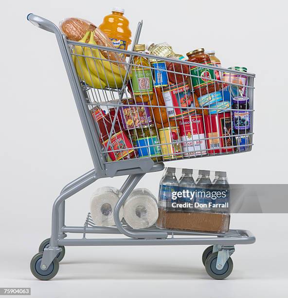 cart full of groceries - stacked canned food stock pictures, royalty-free photos & images