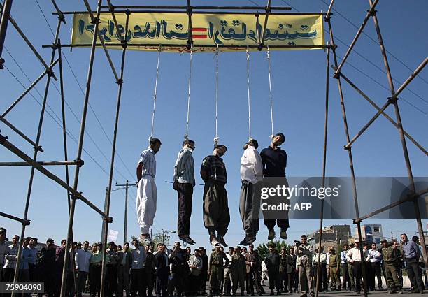 Five people hang limply from the nooses after they were executed in Iran's holy second city of Mashhad, 01 August 2007. Iran hanged in public seven...