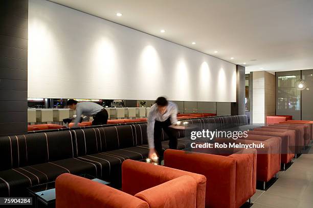 server putting candles down in restaurant lounge - serveur restaurant stock pictures, royalty-free photos & images