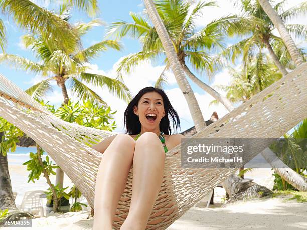 woman sitting on hammock, laughing - michael sit stock pictures, royalty-free photos & images