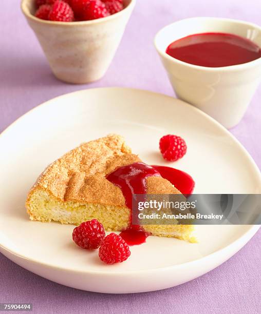 almond sponge cake with fresh raspberries, close-up - raspberry coulis stock pictures, royalty-free photos & images