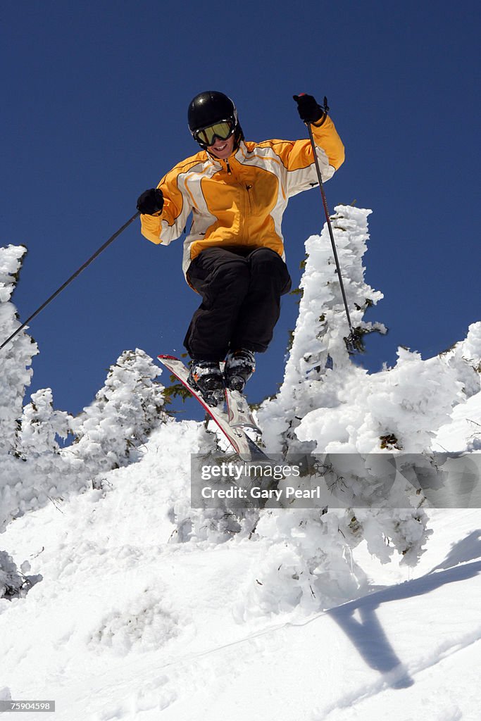 Male skier descending slope, front view