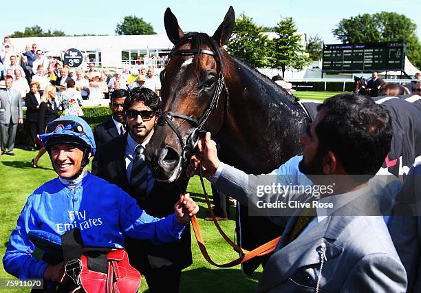 Frankie Dettori celebrates with Sheikh Mohammed and his winning mount Ramonti after winning The BGC Sussex stakes run at Goodwood Racecourse on...