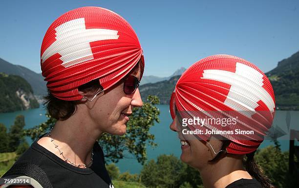 Maria and Natascha, decorated with Swiss flags, attend the Ruetli celebrations on August 1 near Luzern, Switzerland. Every year the reenactment of...