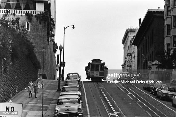 The cable cars are a noted feature of the city, even if they don't climb halfway to the stars, in early summer 1967 in San Francisco, California.