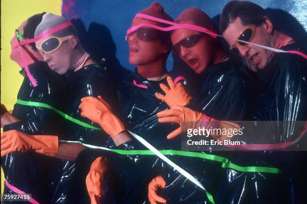 Bob Mothersbaugh, Mark Mothersbaugh, Alan Myers, Gerald Casale and Bob Casale of the punk new wave music group "Devo" pose for a portrait covered in...