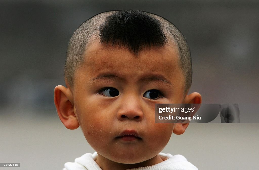 A Chinese boy sports a traditional hairstyle on June 1, 2007 in... News  Photo - Getty Images
