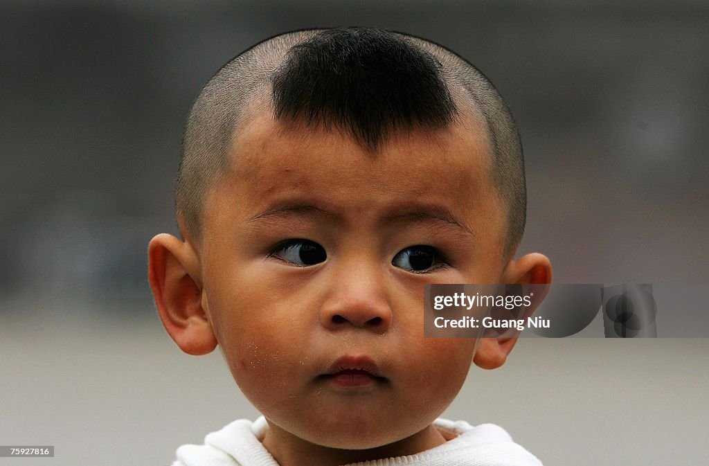 A Chinese boy sports a traditional hairstyle on June 1, 2007 in... News Photo - Getty Images A Chinese boy sports a traditional hairstyle on June 1, 2007 in... News Photo - Getty Images