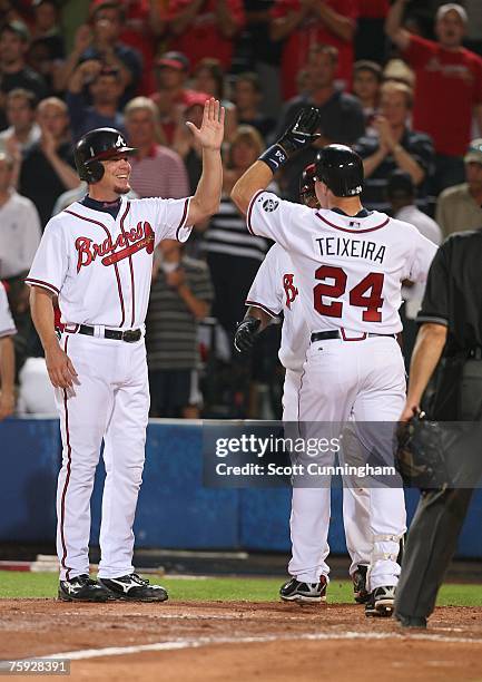 Mark Teixeira of the Atlanta Braves is congratulated by Chipper Jones after hitting a 6th inning home run against the Houston Astros at Turner Field...